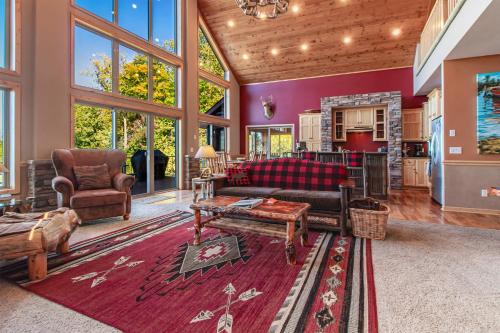 a living room with a couch and a table at Spacious Leech Lake Home on 2 Private Acres, 200' of lake shore 15 Minutes to Walker with boat lift, dock, swimming, fire pit in Walker