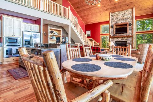a kitchen and dining room with a table and chairs at Spacious Leech Lake Home on 2 Private Acres, 200' of lake shore 15 Minutes to Walker with boat lift, dock, swimming, fire pit in Walker