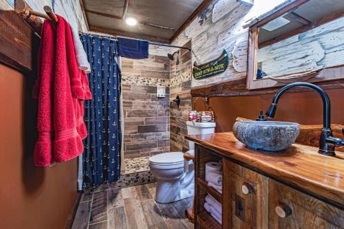 a bathroom with a toilet and a sink at Spacious Leech Lake Home on 2 Private Acres, 200' of lake shore 15 Minutes to Walker with boat lift, dock, swimming, fire pit in Walker