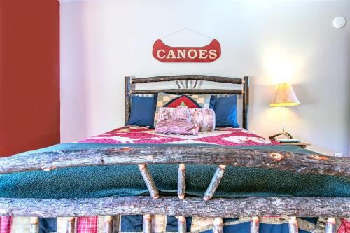 a bedroom with a bed with a sign on the wall at Spacious Leech Lake Home on 2 Private Acres, 200' of lake shore 15 Minutes to Walker with boat lift, dock, swimming, fire pit in Walker