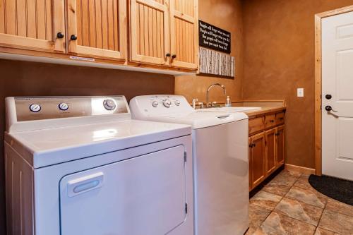 a laundry room with a washer and a sink at Spacious Leech Lake Home on 2 Private Acres, 200' of lake shore 15 Minutes to Walker with boat lift, dock, swimming, fire pit in Walker