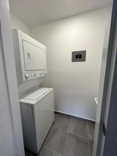 a small bathroom with a washer and dryer at Depa en La Cienega in Tijuana