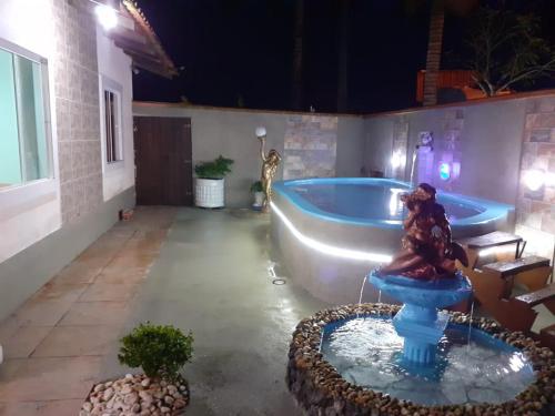 a large bathroom with a tub and a sink at Doce Lar in Itapoa