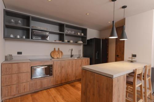 a kitchen with wooden cabinets and a counter top at Kiin Living- "Child-free coliving" in Medellín