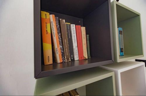a book shelf with a bunch of books on it at Luxury Suite Vitruvio 55 in Formia