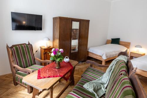 a living room with a couch and a table at Grünes Haus in Murau
