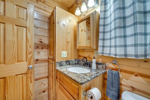 a bathroom with a sink and a toilet at Hot Tub and Deck Broken Bow Azalea House in Broken Bow