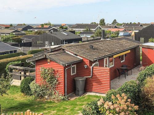 a small red house with a patio in a city at 5 person holiday home in Karrebæksminde in Karrebæksminde