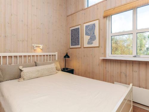 a bedroom with a white bed and two windows at 6 person holiday home in Øster Assels-By Traum in Sillerslev