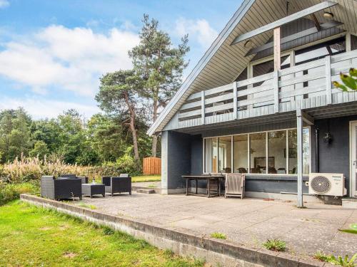 a house with a patio in front of it at 11 person holiday home in Ørsted-By Traum in Ørsted