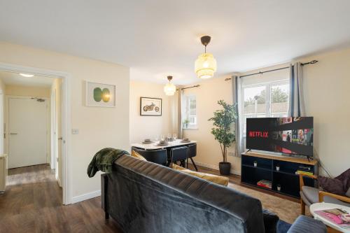 a living room with a couch and a tv at 2-bed -Free parking- Excel - Canning Town- Canary Wharf in London