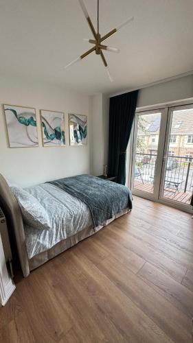 a bedroom with a bed and a ceiling fan at Stylish Guest home in Dublin