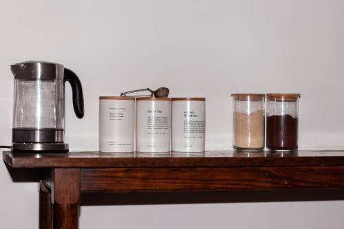 a group of five jars on a wooden table at Nest at Maggies in Melbourne