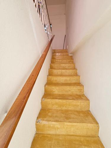 a stairway in a room with wooden stairs at Departamento El Dorado in Barrio Nuevo