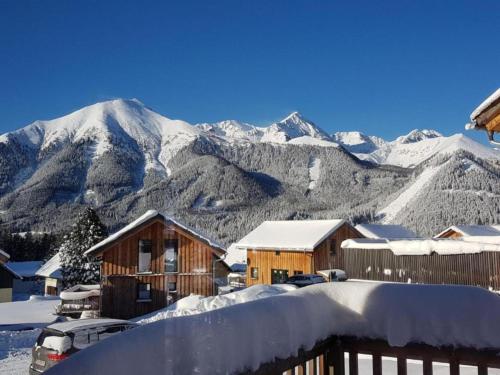 a snow covered mountain range with houses and cars at Bärenschanze in Hohentauern
