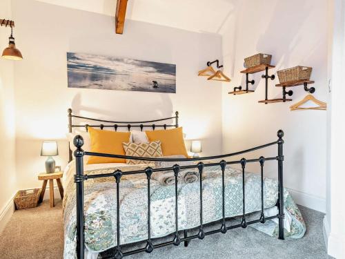 a bedroom with a black bed with yellow pillows at 2 Bed in Taunton 93581 in Norton Fitzwarren