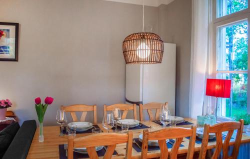 a dining room with a table and chairs at Cozy Apartment In Storfors With Wifi in Storfors