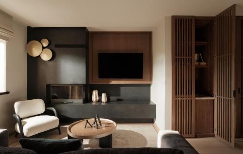 a living room with a couch and a tv at Ceci Suites in Arachova
