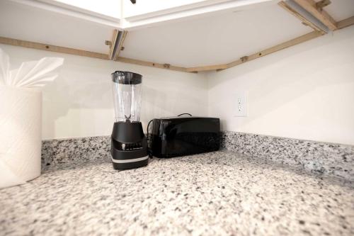 a blender sitting on a counter in a room at 5 Min to Downtown - 12 to Elon - Deck - Wi-Fi in Graham