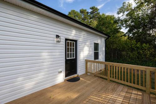 a front door of a house with a wooden deck at 5 Min to Downtown - 12 to Elon - Deck - Wi-Fi in Graham