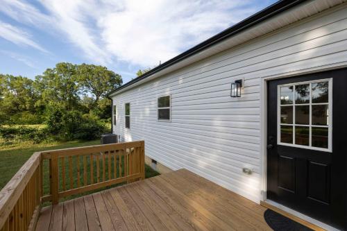 a wooden deck with a door on a house at 5 Min to Downtown - 12 to Elon - Deck - Wi-Fi in Graham