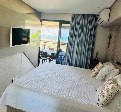 a bedroom with a bed with a view of the ocean at landscap Meireles Fortaleza in Fortaleza