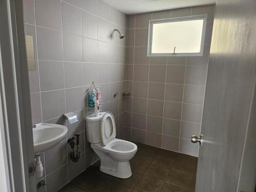 a bathroom with a toilet and a sink at Homestay Saderi Putrajaya Presint 16 in Putrajaya