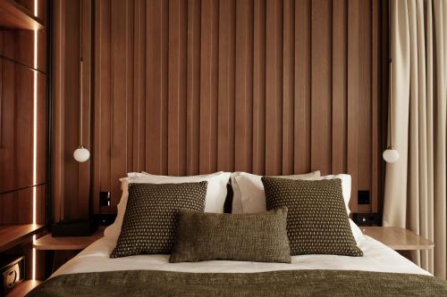 a bedroom with a large bed with pillows at Ceci Suites in Arachova