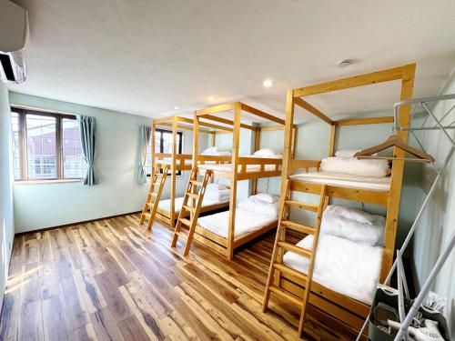 a room with four bunk beds in it at FujiBaseGotemba Sta 3-mins walk in Gotemba