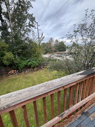 a wooden deck with a view of a yard at Upscale Anchorage Getaway, Cozy & Newly Remodeled in Anchorage