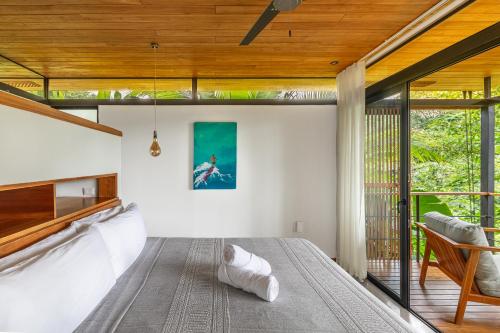 a bedroom with a large bed and a large window at The Green House, Santa Teresa - Adults Only in Santa Teresa Beach