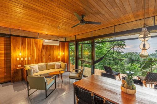 a living room with a couch and a table at The Green House, Santa Teresa - Adults Only in Santa Teresa Beach