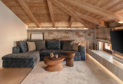 a living room with a couch and a table at Ceci Suites in Arachova