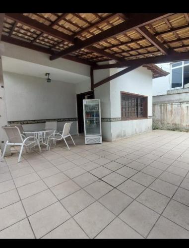 a patio with chairs and a table in a building at Beach Milionario in Guarujá