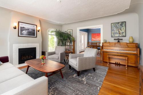 a living room with a piano and a couch at Classic Palo Alto Home & Neighborhood in Palo Alto