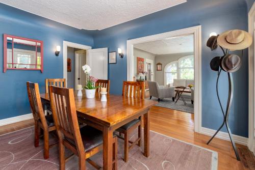 a dining room with blue walls and a wooden table at Classic Palo Alto Home & Neighborhood in Palo Alto