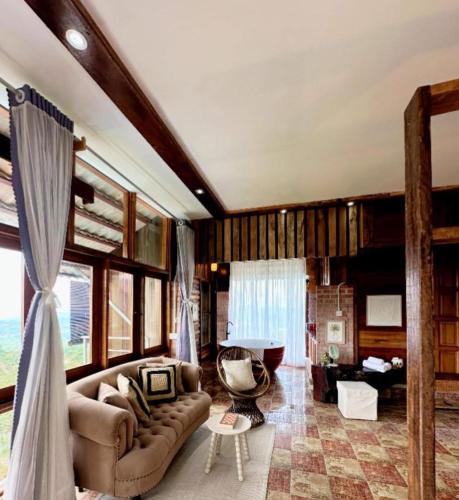 a living room with a couch and a chair at SANKARA GARDEN in Pantai