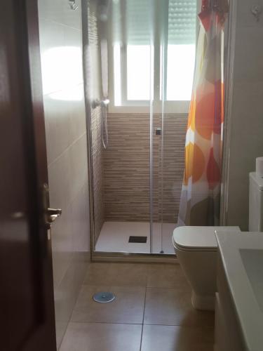 a bathroom with a shower and a toilet at 12jazmines in Castillo de BaÃ±os