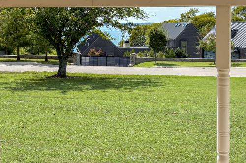 a yard with a tree and a house at Walk to Marina Family Home with Yard in Kingston in Shay