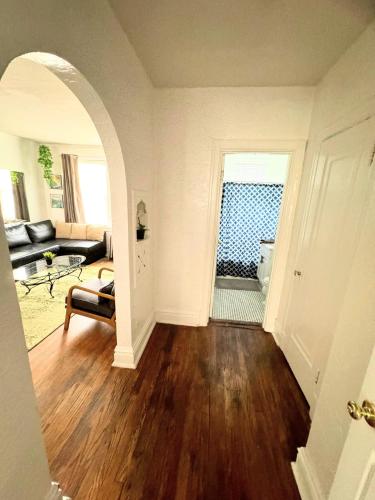 an open living room with a couch and a table at (53.1S) Forest Park, The Zoo, and much more in Saint Louis