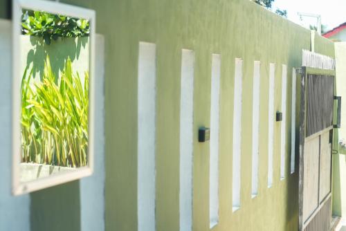 a white fence with a window on a building at NH Villa Lombok in Sangyang