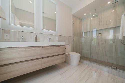 a bathroom with a toilet and a glass shower at Modern Home 3BR 2BA - 20 Min to NYC in Jersey City