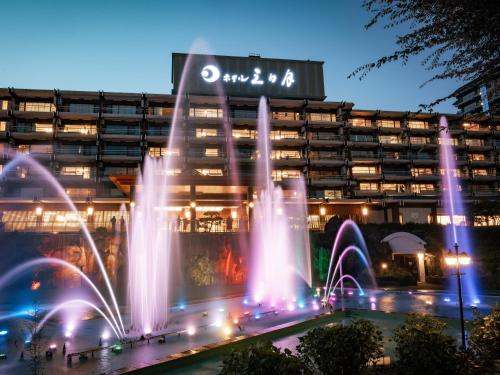 a large building with a fountain in front of it at Kinugawa Hotel Mikazuki in Nikko