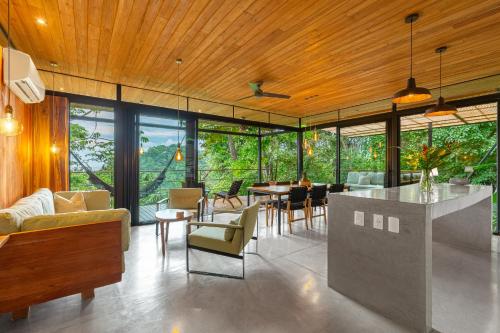 a living room with a table and chairs at The Green House, Santa Teresa - Adults Only in Santa Teresa Beach
