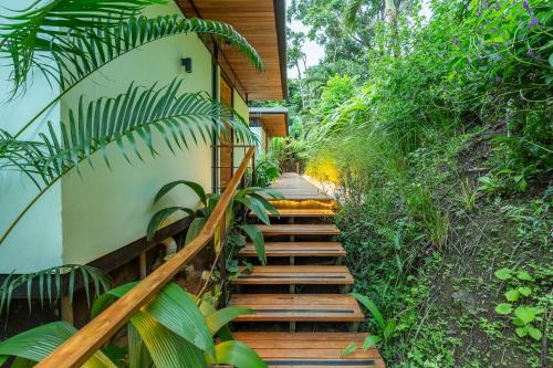 a set of wooden stairs leading up to a house at The Green House, Santa Teresa - Adults Only in Santa Teresa Beach