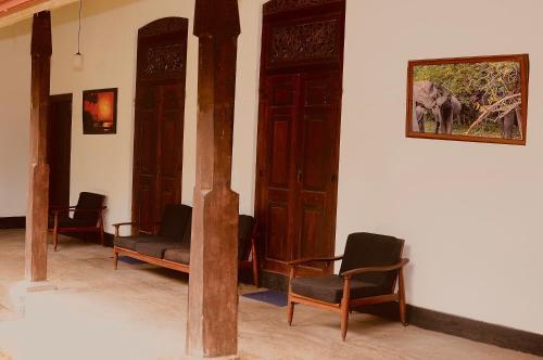 a waiting room with chairs and a picture of an elephant at Stuart House Tangalle in Tangalle