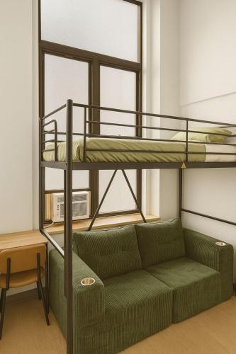a living room with a couch and a bunk bed at CityNest Hotel in New York