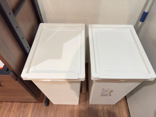 two white refrigerators sitting next to each other at The Maruko in Abiko