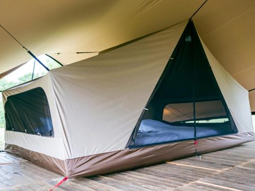 a tent is set up on a wooden floor at SNOW PEAK FIELD SUITE SPA HEADQUARTERS in Morimachi