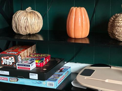 a shelf with snacks and a phone and a pumpkin at Cozy 1bd apartment in the heart of Liverpool NY in Liverpool